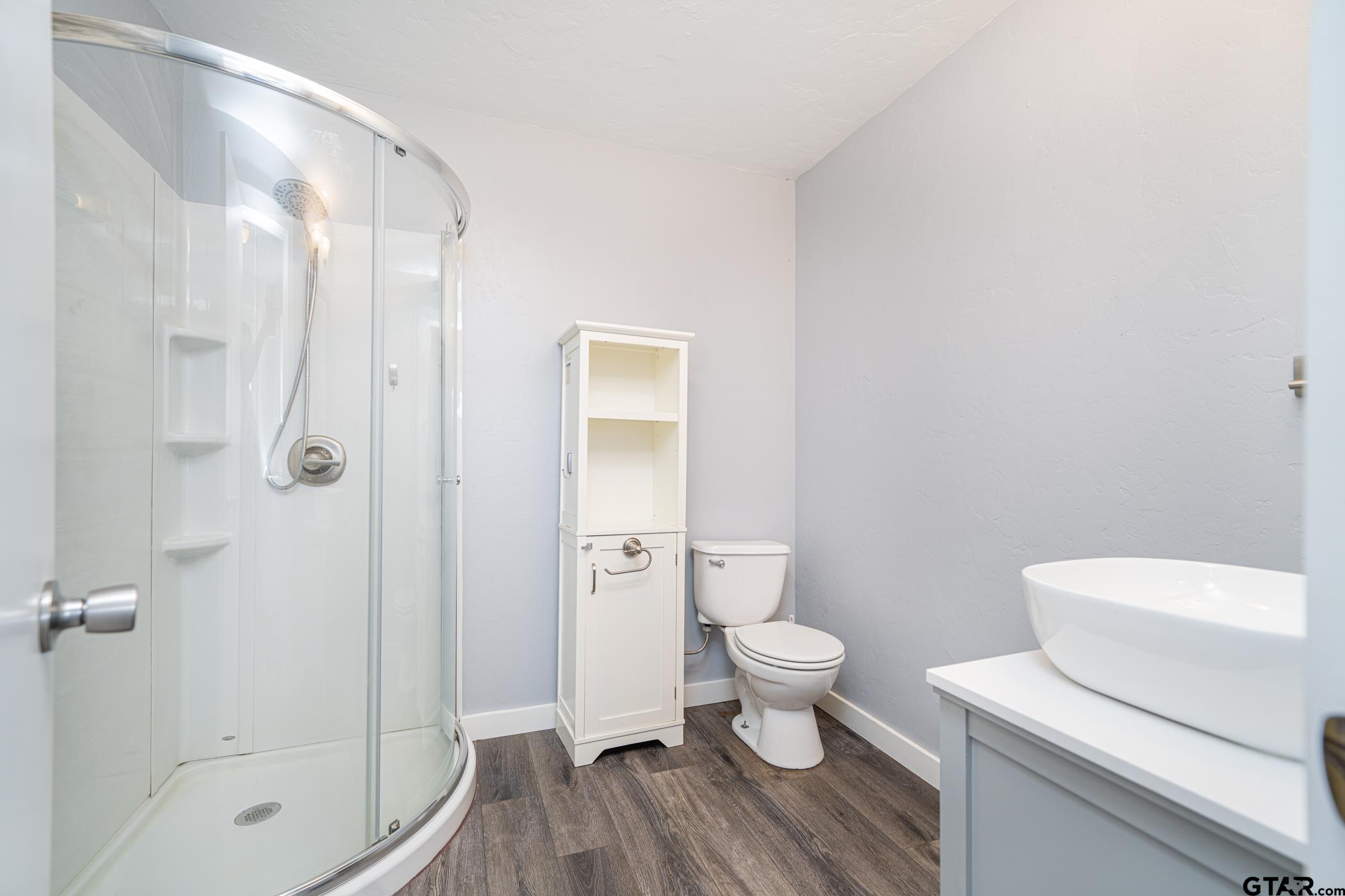 1855 Phillips Springs Road Gladewater, TX 75647 - Photo 33 of 36 a bathroom with a toilet a sink and shower