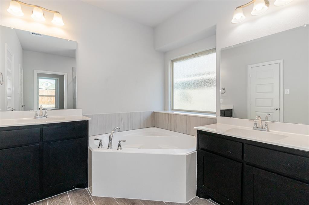 232 Cisco Trail Forney, TX 75126 - Photo 11 of 27 a bathroom with a tub sink and mirror