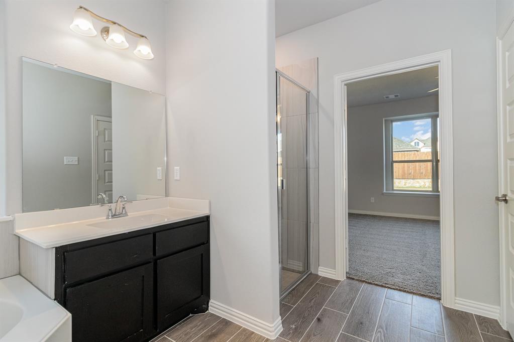 232 Cisco Trail Forney, TX 75126 - Photo 12 of 27 a bathroom with a sink and a mirror