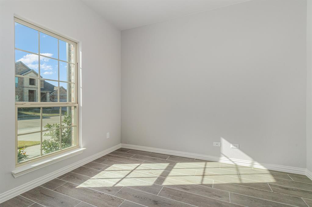 232 Cisco Trail Forney, TX 75126 - Photo 22 of 27 an empty room with wooden floor and windows