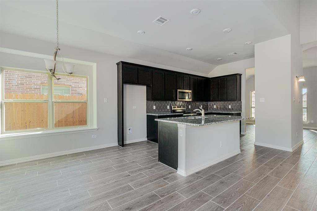 232 Cisco Trail Forney, TX 75126 - Photo 24 of 27 a kitchen with stainless steel appliances a refrigerator sink and microwave