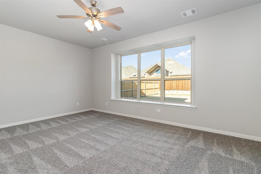 232 Cisco Trail Forney, TX 75126 - Photo 8 of 27 an empty room with a window and a fan