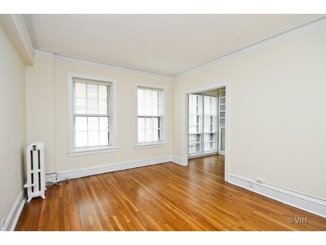 400 West Deming Place, Unit 6G Chicago, IL 60614 - Photo 5 of 11 an empty room with wooden floor and windows
