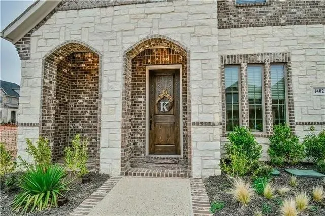 a dining room with furniture a chandelier and wooden floor