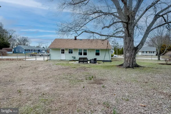 a view of a large house with a yard and large tree