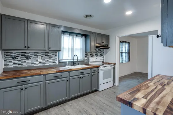 a kitchen with sink cabinets and window