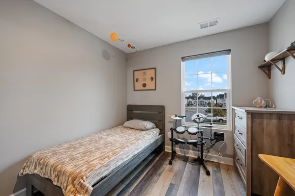 a bedroom with a bed and a table in it