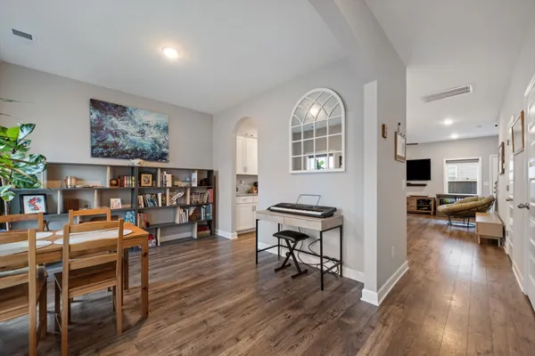 a living room with furniture and a wooden floor
