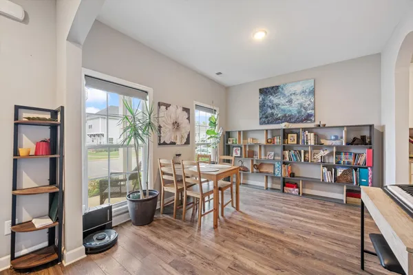 a living room with furniture and a book shelf