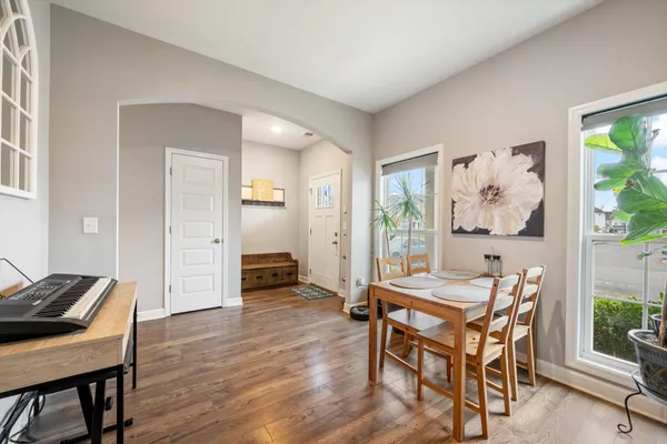 a dining room with furniture and wooden floor