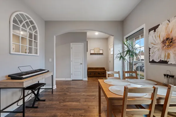 a view of a dining room with furniture and a potted plant