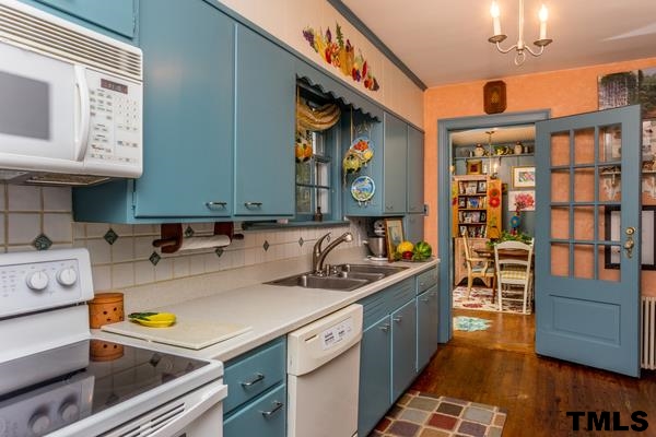 1103 Harvey Street Raleigh, NC 27608 - Photo 11 of 25 a kitchen with a sink and cabinets