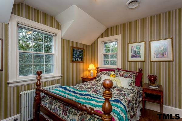 1103 Harvey Street Raleigh, NC 27608 - Photo 18 of 25 a bed room with furniture and a window