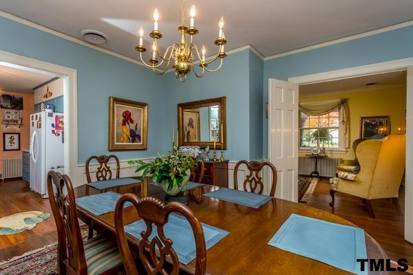 1103 Harvey Street Raleigh, NC 27608 - Photo 9 of 25 a living room with furniture and a chandelier