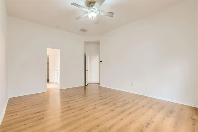 a spacious bedroom with a bed and a couch