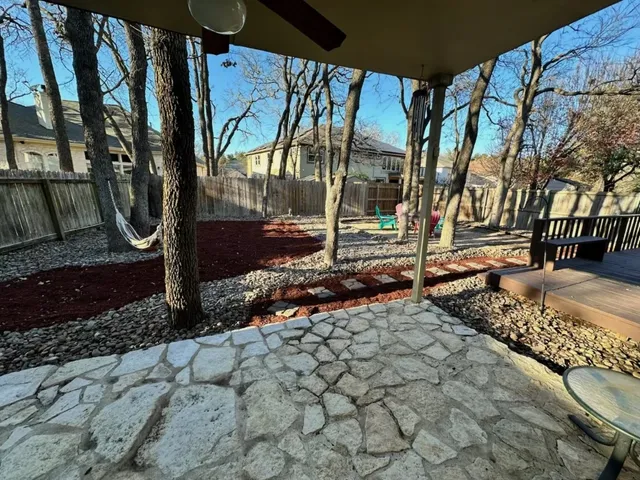 a backyard of a house with table and chairs