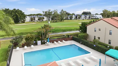 a view of a swimming pool with a yard