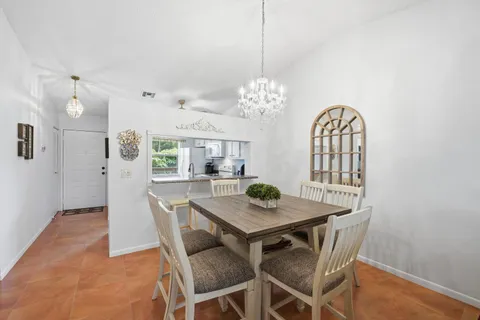 a view of a dining room with furniture and a chandelier