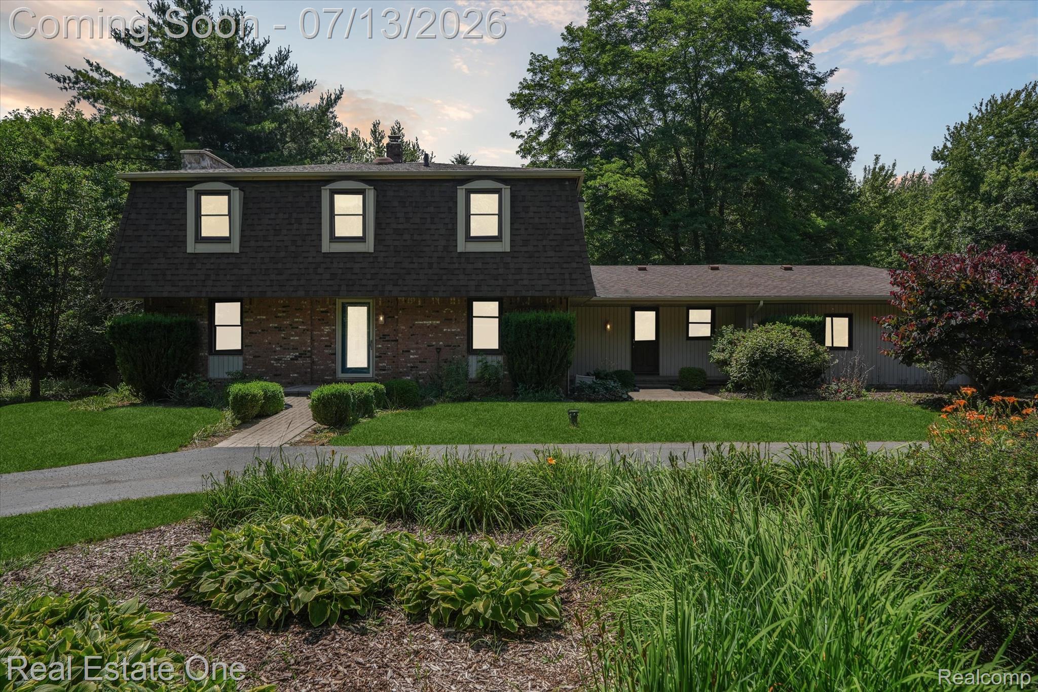 6039 Fish Lake Road Holly, MI 48442 - Photo 66 of 70 Dutch colonial with a chimney, a front yard, brick, vinyl & Cultured Stone siding, and a gabled style roof. Circular driveway with beautiful gardens.