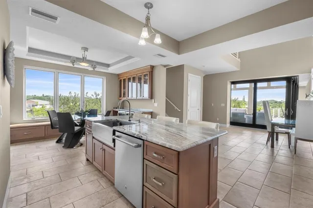 a spacious bedroom with a bed and a chandelier