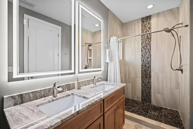a bathroom with a granite countertop sink a toilet and a mirror