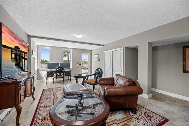 a view of a balcony with floor to ceiling windows with wooden floor