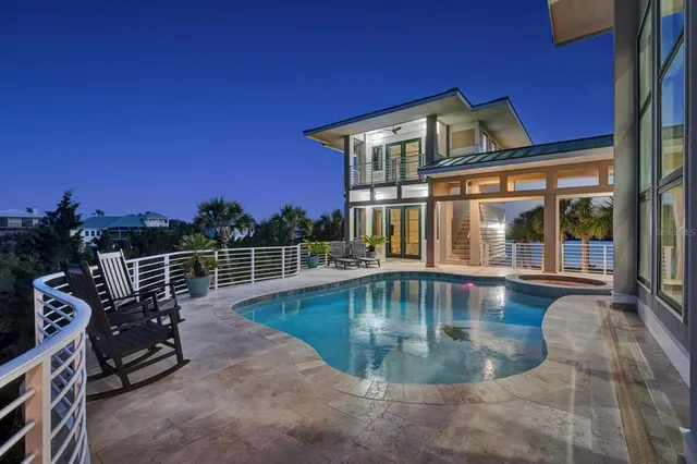 a living room with furniture and floor to ceiling windows
