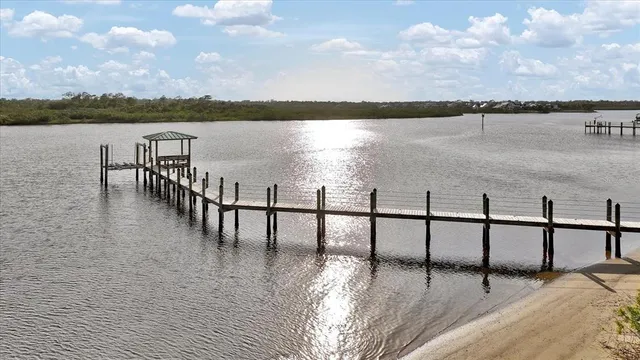 a view of a hallway with dining area and glass door