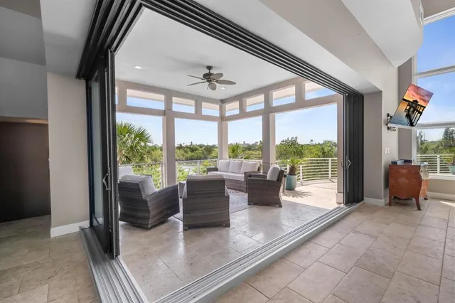 a view of a dining room with furniture and a large window