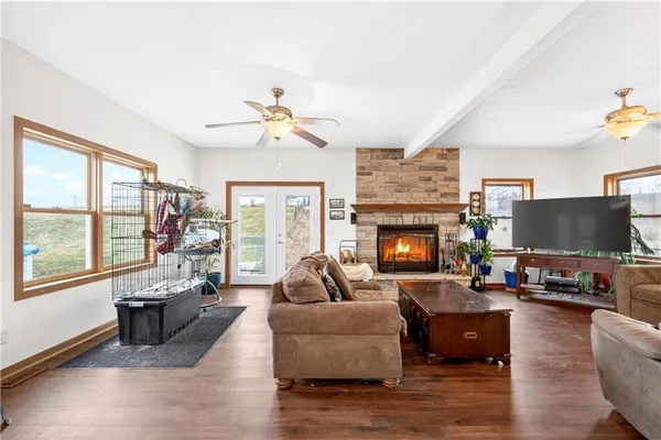 a living room with furniture a fireplace and a flat screen tv