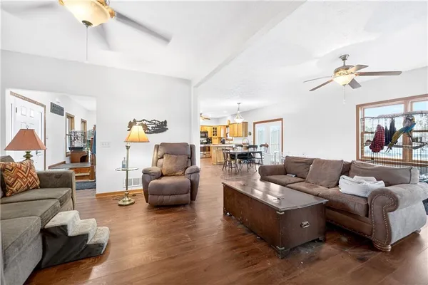 a living room with furniture or couch and a ceiling fan