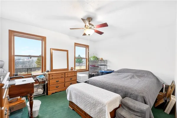 a bedroom with furniture and a large window