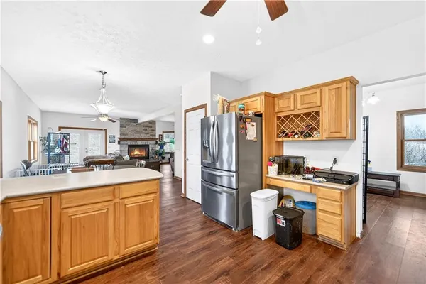 a kitchen that has a lot of cabinets stainless steel appliances and wooden floor
