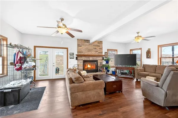 a living room with furniture a flat screen tv and a fireplace
