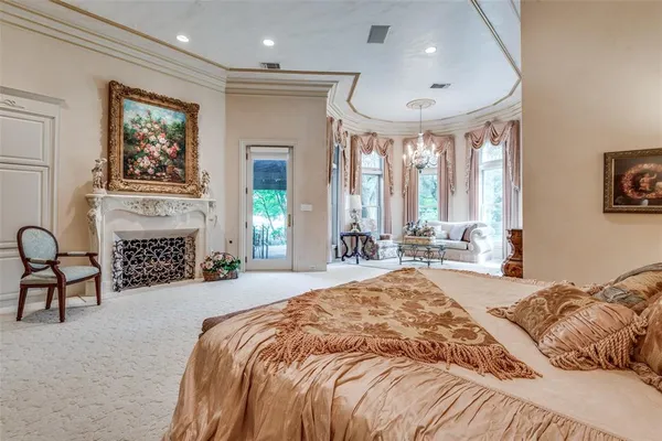 a spacious bedroom with a bed a large window with table and chairs