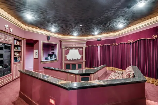 a living room with furniture and floor to ceiling windows