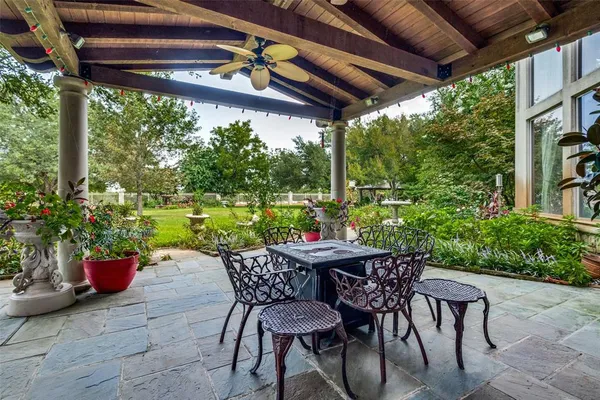 a view of a building with a big yard and large trees