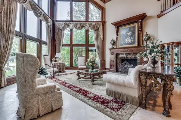 a living room with furniture and floor to ceiling windows