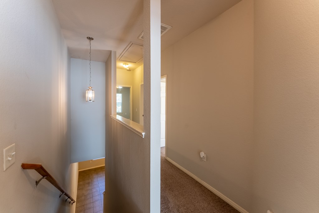 3000 Govalle Avenue, Unit B Austin, TX 78702 - Photo 14 of 26 Corridor featuring an upstairs landing and dark colored carpet