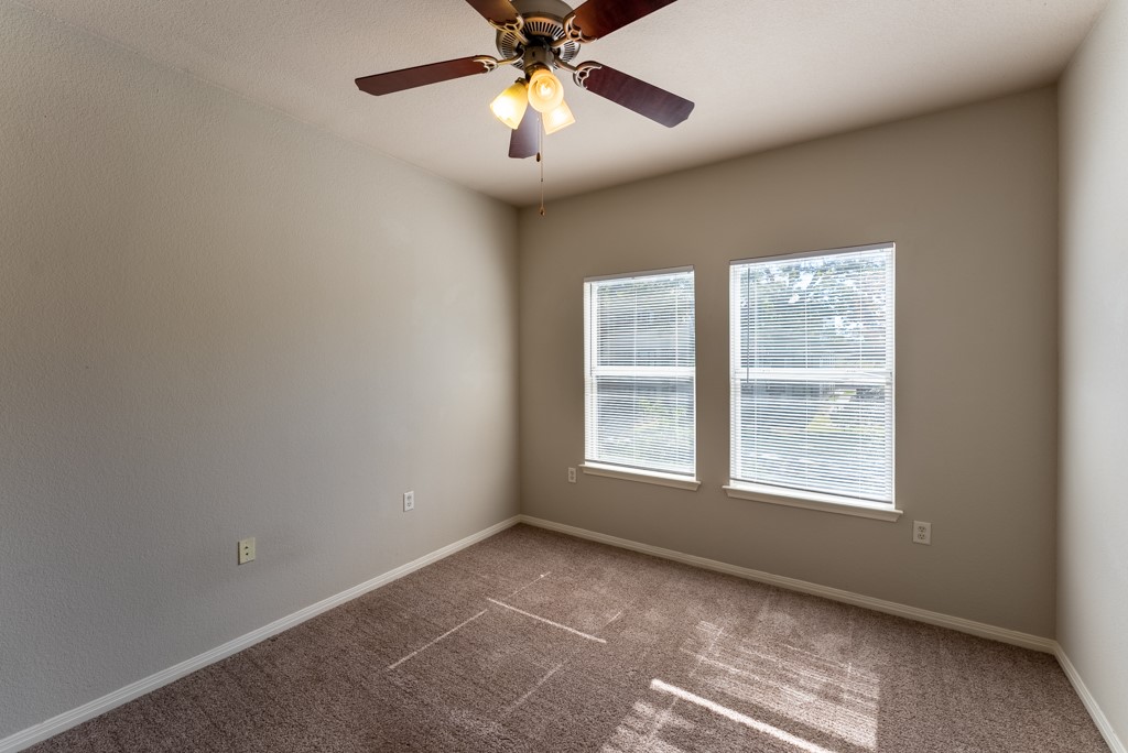 3000 Govalle Avenue, Unit B Austin, TX 78702 - Photo 15 of 26 Carpeted spare room with baseboards and ceiling fan