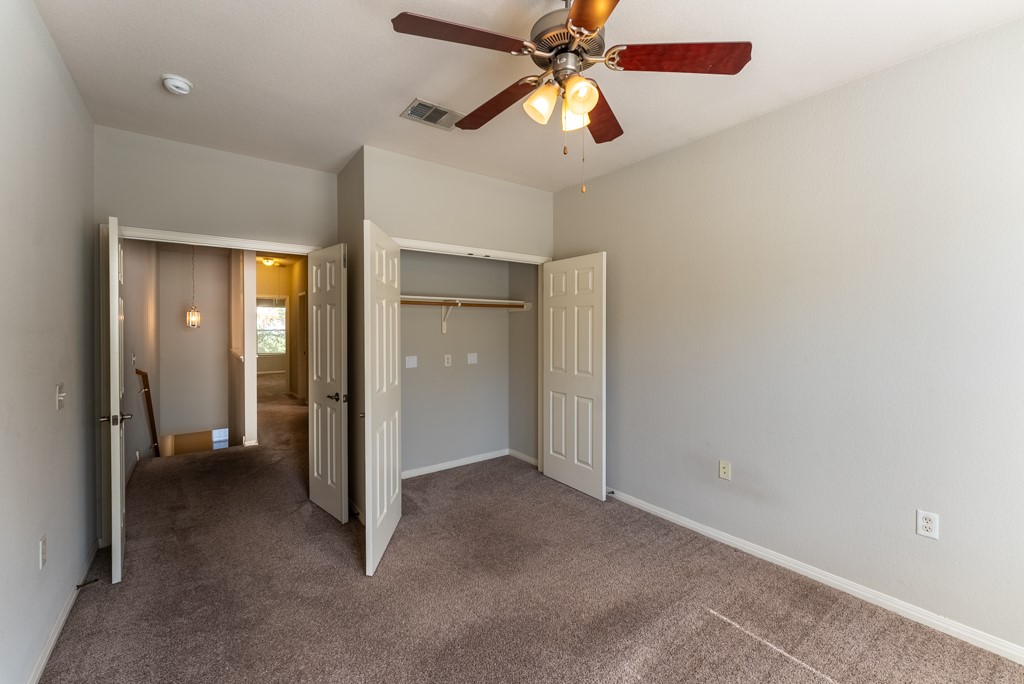 3000 Govalle Avenue, Unit B Austin, TX 78702 - Photo 16 of 26 Unfurnished bedroom with carpet, a closet, and ceiling fan