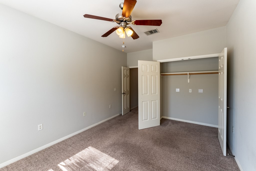 3000 Govalle Avenue, Unit B Austin, TX 78702 - Photo 17 of 26 Unfurnished bedroom with carpet, a ceiling fan, and a closet