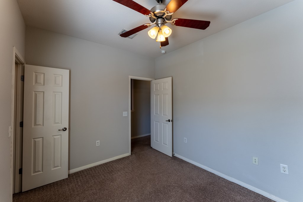 3000 Govalle Avenue, Unit B Austin, TX 78702 - Photo 20 of 26 Unfurnished bedroom featuring carpet flooring and ceiling fan