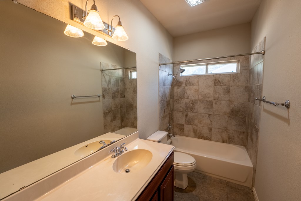 3000 Govalle Avenue, Unit B Austin, TX 78702 - Photo 21 of 26 Bathroom with vanity, shower / washtub combination, and tile patterned flooring