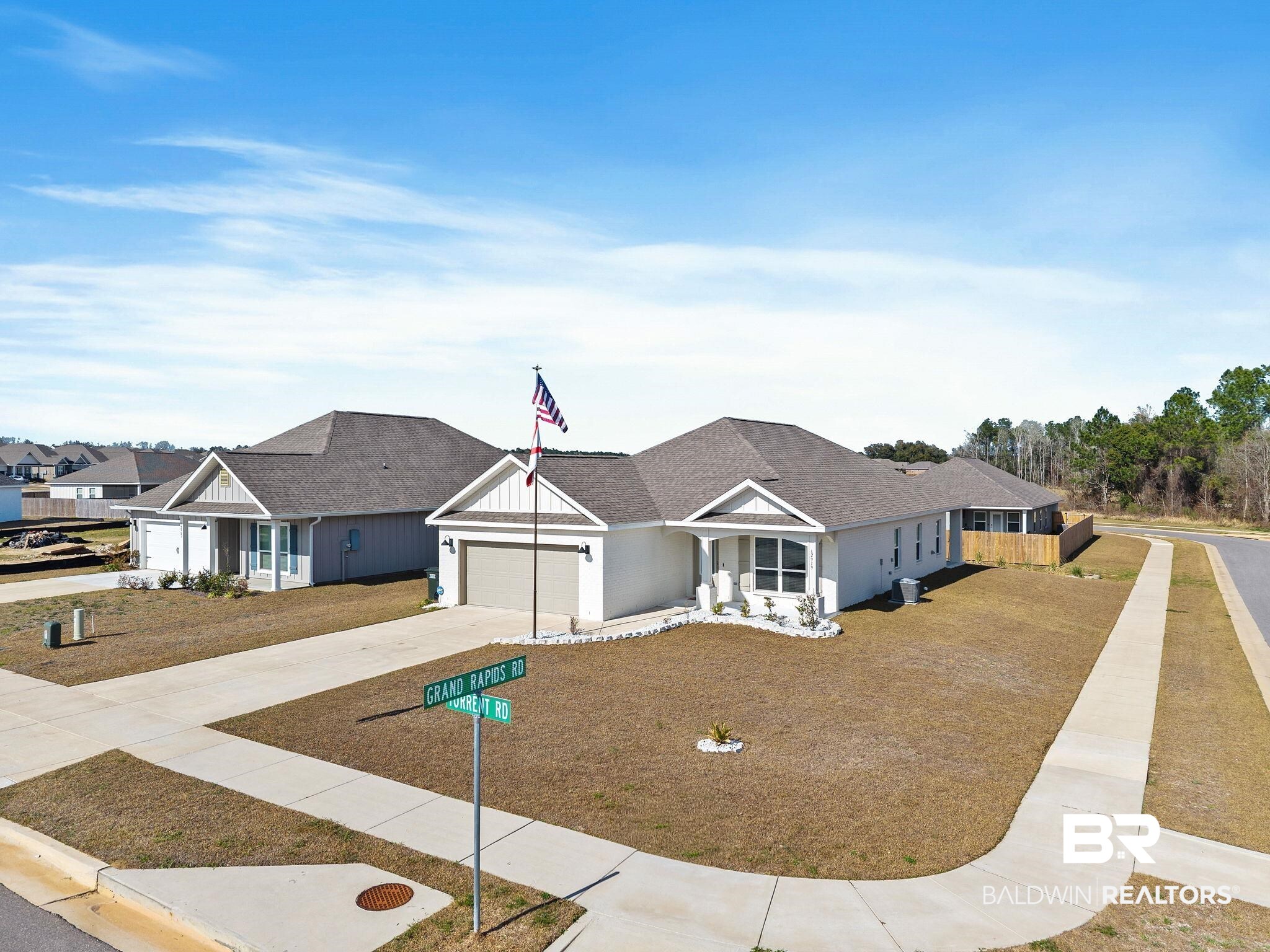 12919 Torrent Road Fairhope, AL 36532 - Photo 55 of 74 View of front of house featuring driveway, roof with shingles, and a garage
