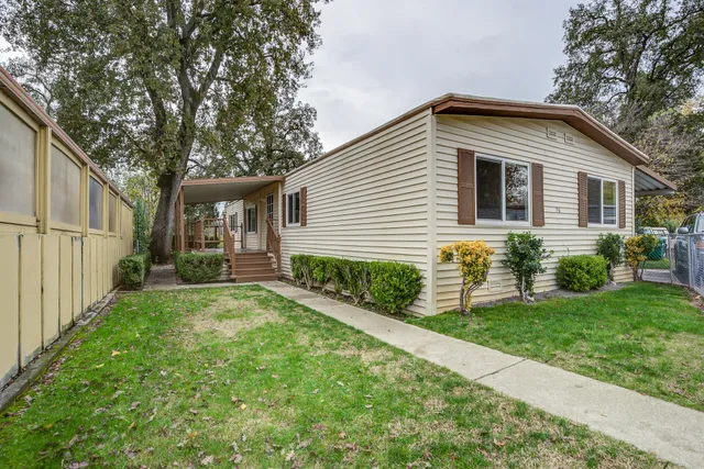 a front view of house with yard and green space