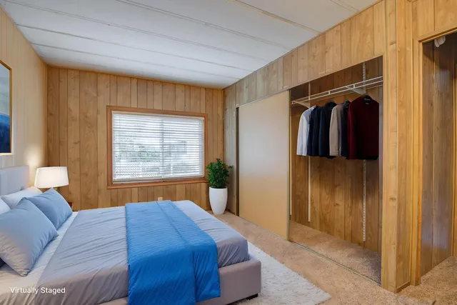 a bedroom with a bed and a walk in closet