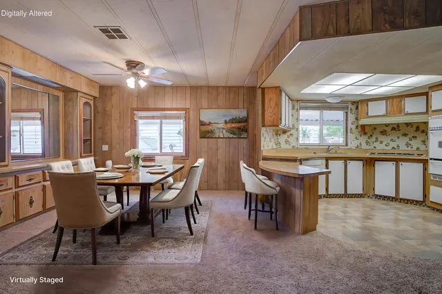 a dining room with a wooden table and chairs