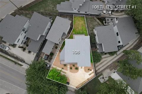 an aerial view of multiple houses with a yard