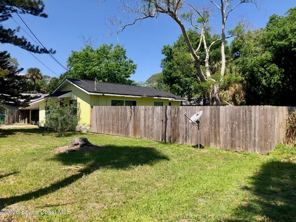 a view of a house with a yard and plants